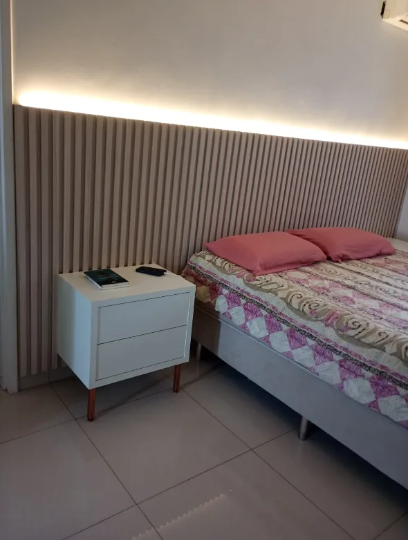 Quarto com cabeceira ripada planejada e criado-mudo sob medida
